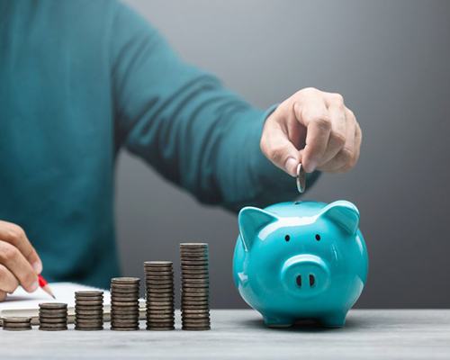 a person putting coins in a piggy bank